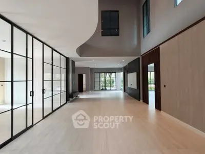 Spacious modern living room with high ceilings and large windows