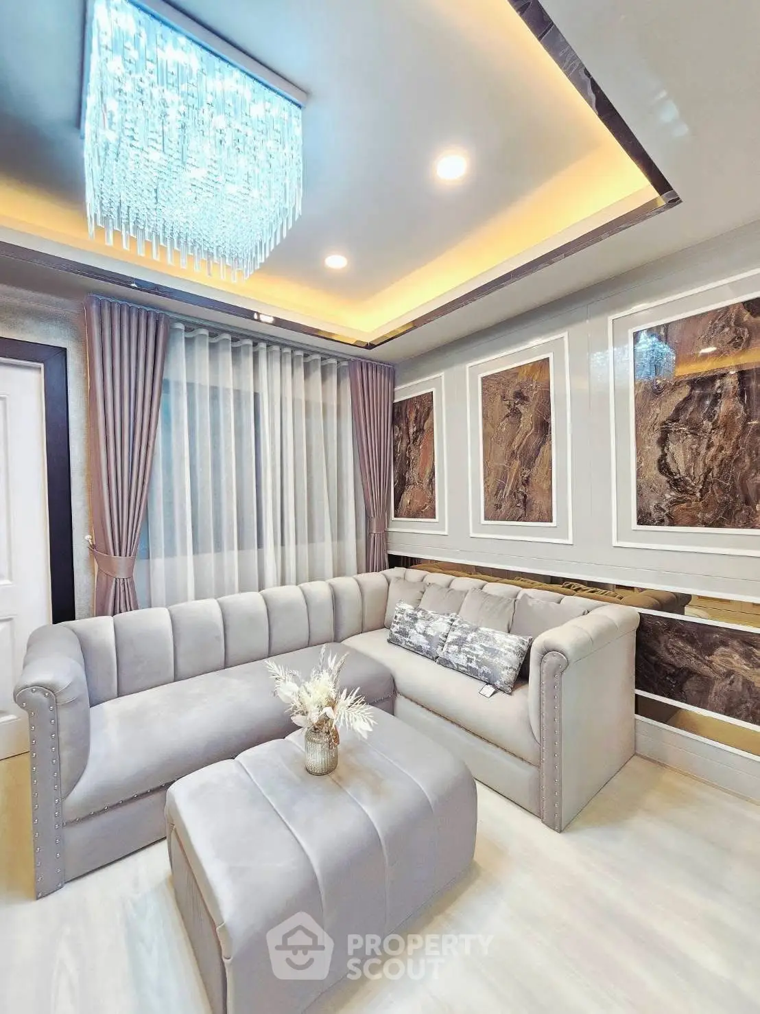 Luxurious living room with elegant sofas and modern chandelier