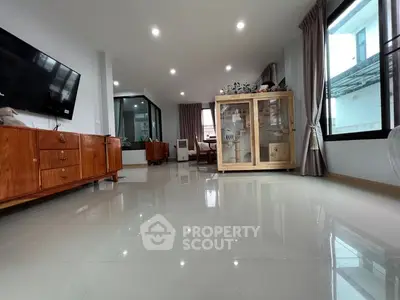 Spacious living room with modern furnishings and large windows for natural light.