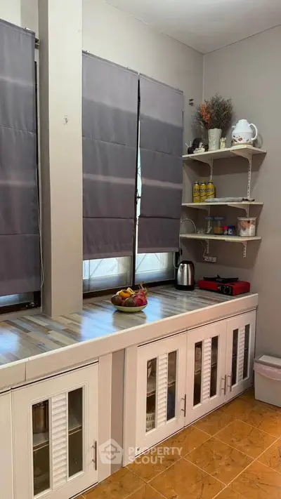 Charming kitchen with ample storage and natural light, featuring modern appliances and cozy decor.