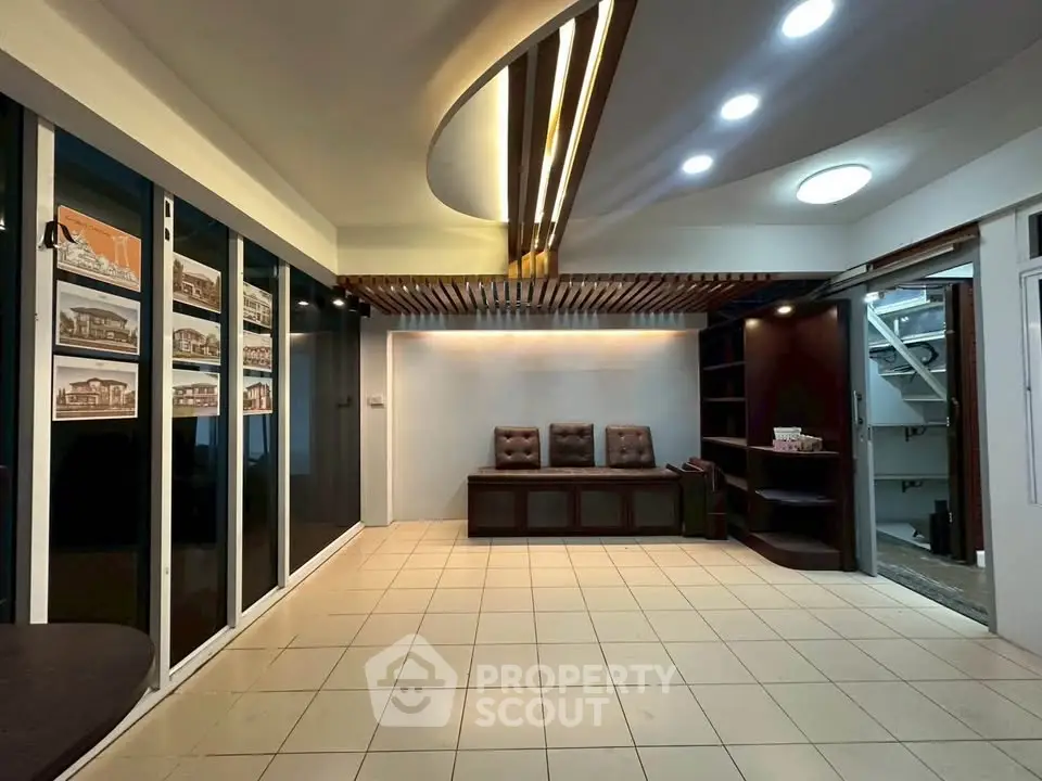 Spacious modern office lobby with stylish ceiling lights and tiled flooring