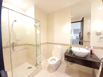 Spacious modern bathroom with glass shower and elegant fixtures