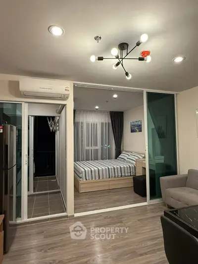 Modern apartment with open layout, featuring a cozy bedroom and stylish living area.