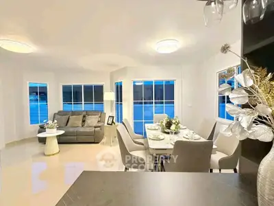 Elegant living and dining area with modern decor and ample natural light