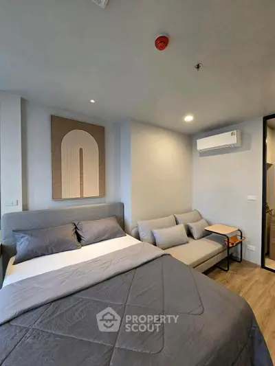 Modern bedroom with stylish decor and comfortable furnishings in a cozy apartment.