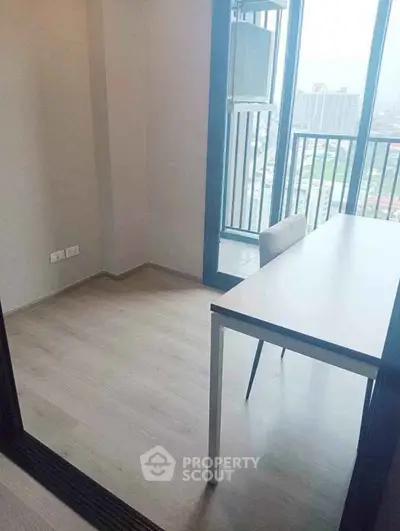 Modern study room with balcony view in high-rise apartment