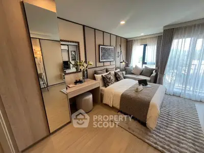 Luxurious bedroom with elegant decor and large windows offering natural light.