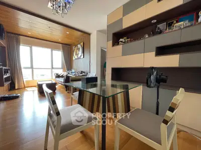 Modern living room with stylish furniture and large windows offering natural light