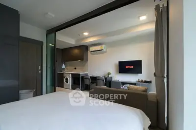 Modern studio apartment with open layout, featuring a cozy living area, kitchen, and bedroom.