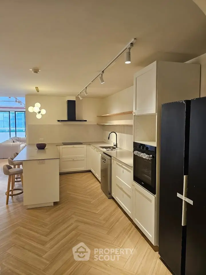 Modern kitchen with sleek appliances and open layout in a stylish apartment.