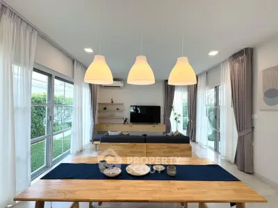 Spacious modern living room with large windows and stylish decor