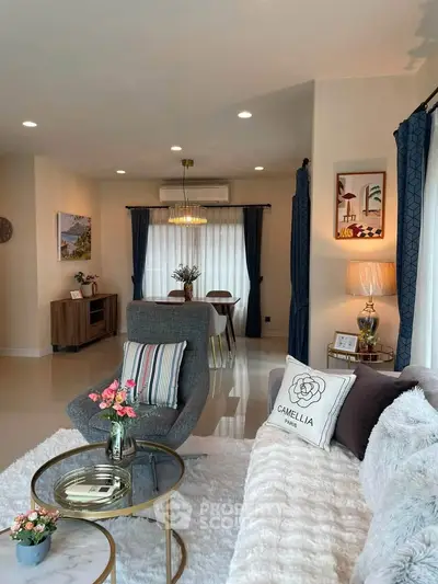Elegant living room with modern decor, plush seating, and stylish lighting, perfect for relaxation and entertaining.