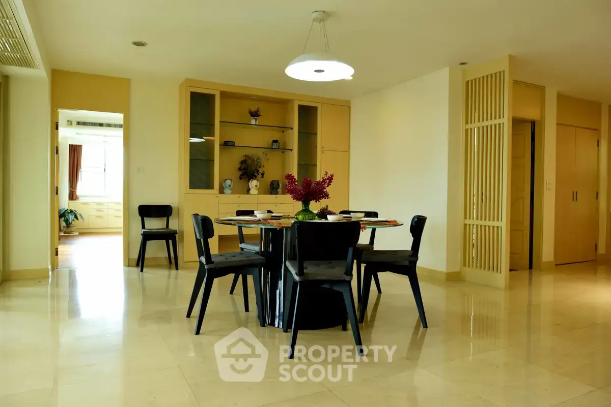 Spacious dining area with modern decor and elegant lighting in a luxurious apartment.