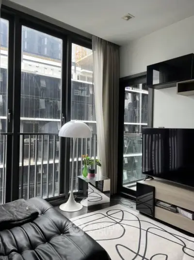 Modern living room with large windows and stylish decor in urban apartment