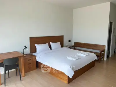 Spacious bedroom with modern wooden furniture and cozy ambiance
