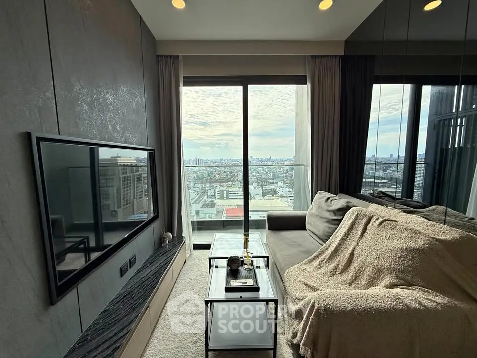 Modern living room with city view, featuring sleek design and cozy seating area.