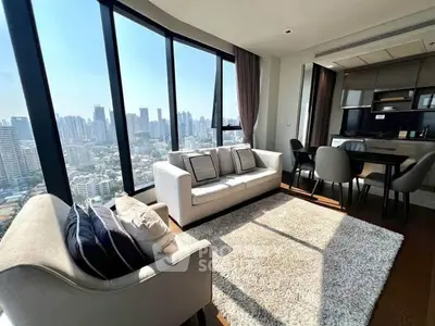 Luxurious living room with stunning city view and modern furniture in high-rise apartment.
