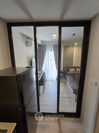 Modern apartment interior with sliding glass doors and stylish living area