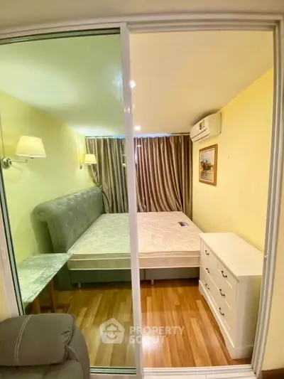 Cozy bedroom with elegant decor and ample natural light, featuring a plush bed and stylish furnishings.