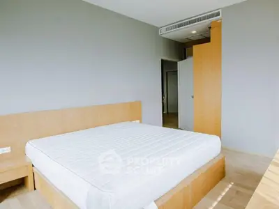 Spacious bedroom with modern wooden furniture and natural light
