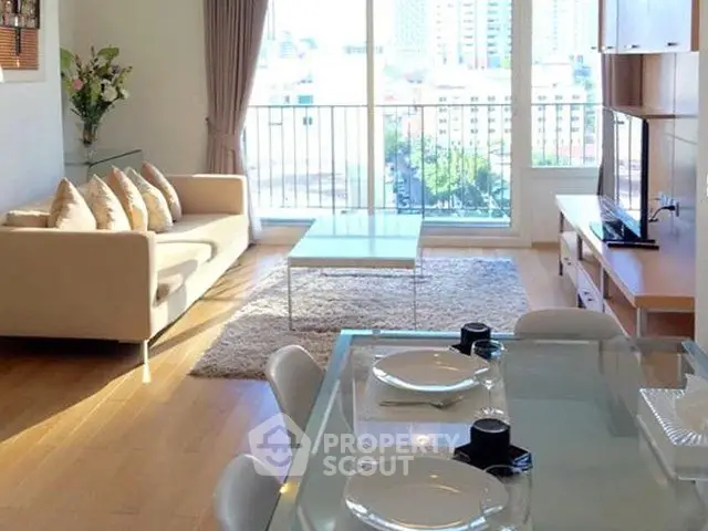 Bright and spacious living room with city view, modern furniture, and elegant decor.