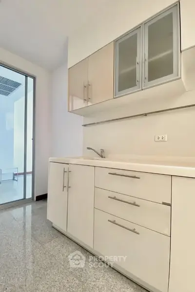 Modern kitchen with sleek cabinets and granite flooring