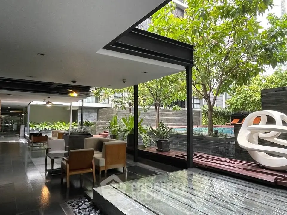 Luxurious modern building with stylish outdoor seating and lush greenery
