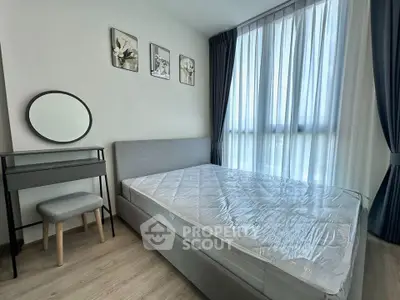 Modern bedroom with large window, stylish decor, and natural light