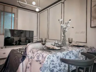 Charming dining area with elegant decor and modern lighting in a cozy living space.