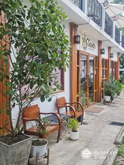 Charming exterior view of a cozy cafe with wooden accents and outdoor seating.