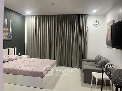 Modern bedroom with stylish decor, featuring a cozy bed, sleek furniture, and elegant curtains.