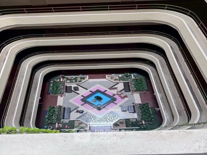Stunning atrium view with lush greenery and modern design in a multi-level building.