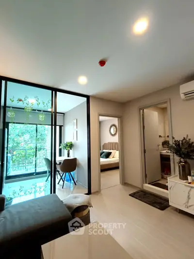 Modern living room with balcony and bedroom view in stylish apartment