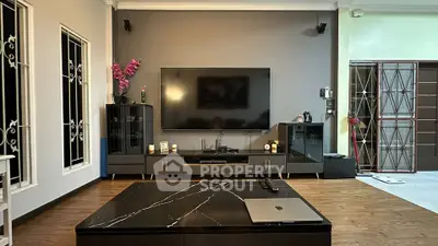 Modern living room with sleek entertainment center and marble coffee table