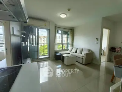 Modern living room with large windows and natural light in a stylish apartment.