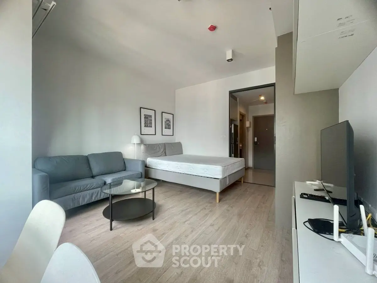 Modern studio apartment with sleek furnishings and natural light