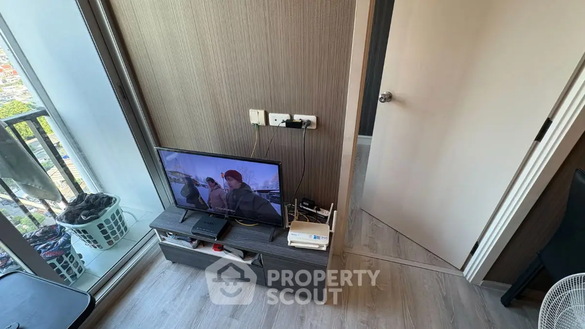 Modern apartment interior with TV and balcony view