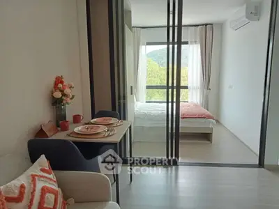 Modern studio apartment with sliding glass doors and scenic view