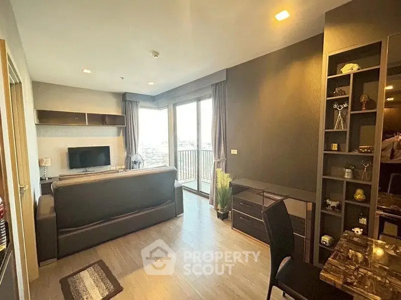 Modern living room with large windows and stylish decor in a high-rise apartment.