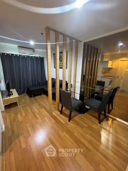 Modern living room with wooden flooring and open kitchen layout