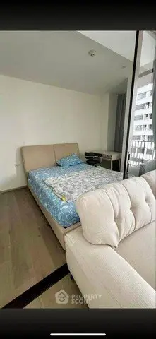 Modern bedroom with cozy bed and balcony view in urban apartment