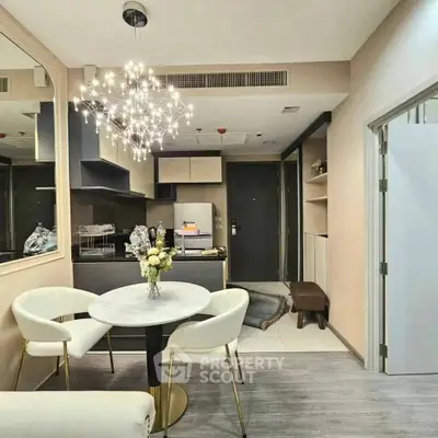 Modern open-layout kitchen and dining area with elegant lighting and stylish decor