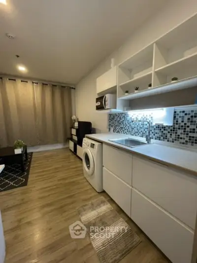 Modern studio apartment with stylish kitchen and washing machine