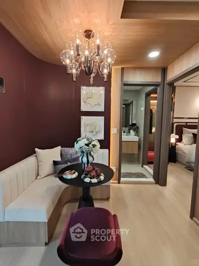 Stylish modern living room with elegant chandelier and cozy seating area