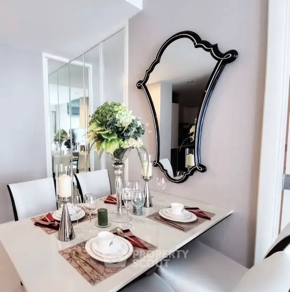 Elegant dining area with stylish mirror and modern table setting