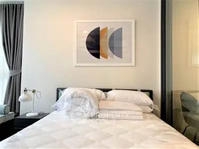 Modern bedroom with stylish decor and cozy bedding in a contemporary apartment.