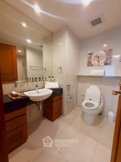 Modern bathroom with sleek fixtures and elegant decor in a contemporary apartment.
