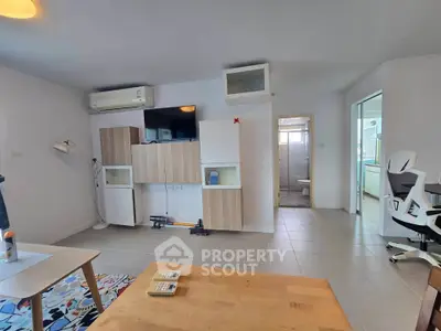 Spacious living room with modern furniture and open layout, perfect for relaxation and entertainment.