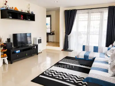 Spacious living room with modern decor and large windows for natural light
