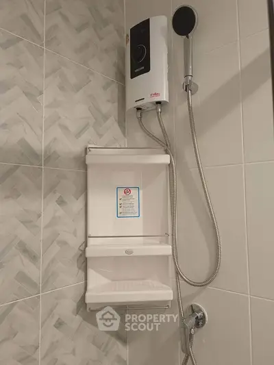 Modern bathroom with sleek shower and water heater, featuring stylish tile design.
